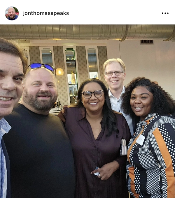 Picture of Jon Thomas with a group of people at an event.